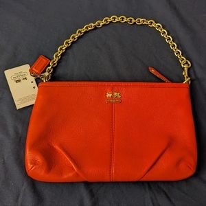 Brand new Coach wristlet in papaya colour with tag